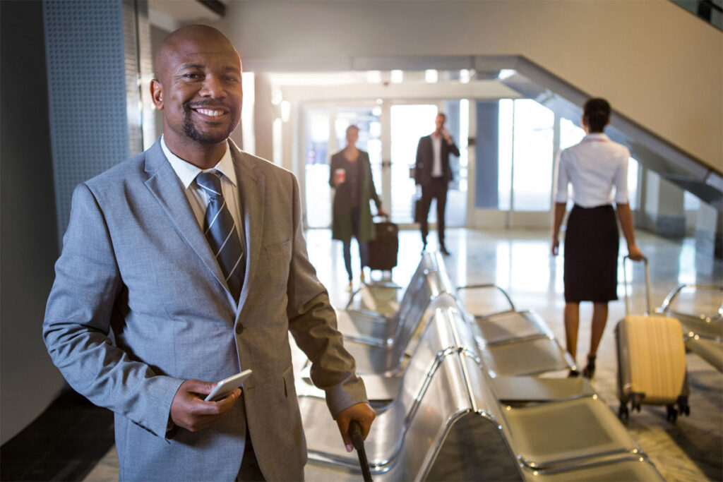 Man-smiling-holding-a-travel-bag